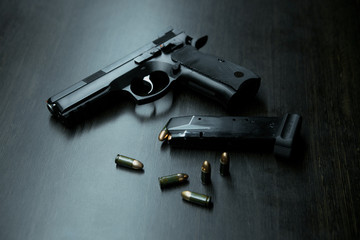 Close-up of a 9mm pistol and ammunition - obrazy, fototapety, plakaty