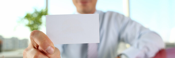 Male arm in suit give blank calling card