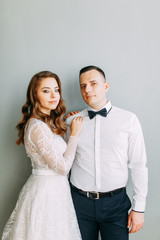 Stylish wedding in European style. Beautiful couple celebrating and drinking champagne in the Studio.