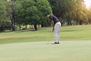Golfer playing golf in beautiful golf course in the evening golf course with sunshine in thailand