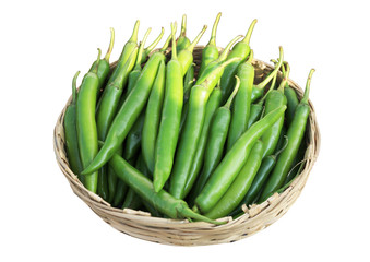 Green chili placed in bamboo basket isolated on a white background