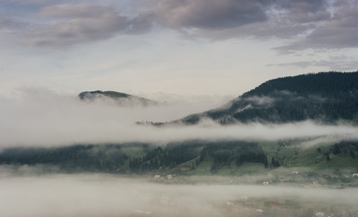 Landscape. Morning in the mountains fog rises from the valley.