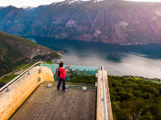 Fototapeta na wymiar Tourist enjoying fjord view on Stegastein viewpoint Norway