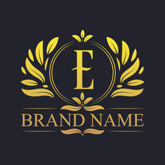 Golden ornamental alphabet E letter logo design. Luxurious golden elegant letter E logo design template.