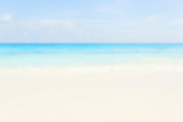 Fototapeta na wymiar Blur summer white sand beach with sparkling sea water