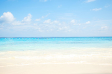 Fototapeta na wymiar Blur summer white sand beach with sparkling sea water