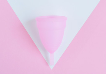 pink menstrual Cup on pink background. woman period concept.
