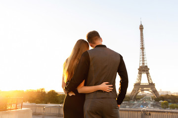 Happy couple looking at Eiffel tower, romantic date in Paris. Honeymoon in France