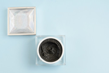 magnetic face mask in a cosmetic jar on blue background