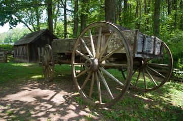 Wooden horse wagon next to a barn