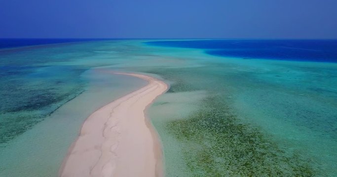 crystal clear water of indian ocean, waves gently splashing on one of the sandbars in Zanzibar Archipelago,