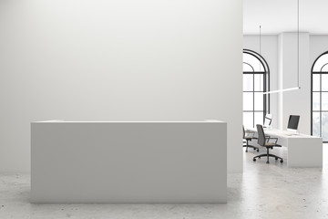 White reception desk in open space office