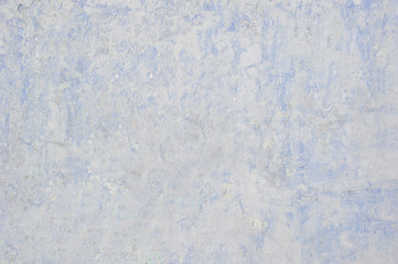 The wall with the remnants of plaster and old paint on gray concrete. Air background effect