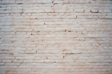Obraz premium White painted brick wall with beige shade of color and volumetric shadows. Textured background