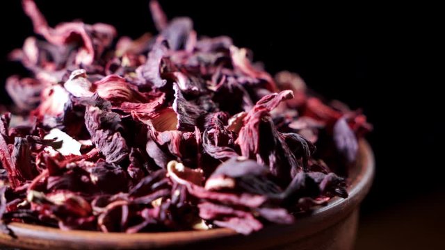 Large leaves of hibiscus red dry tea background, close up. Loop rotation.