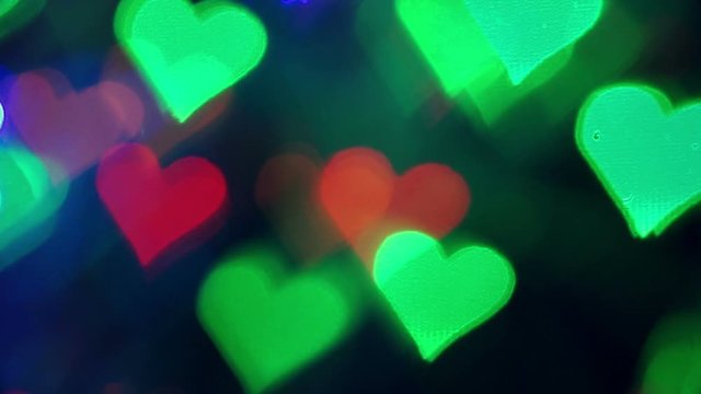 Abstract lights red, yellow and blue color in the shape of a heart . Bokeh background