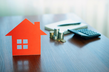 Buying and selling houses and real estate prices. Concept. Man using calculator to count rent money.