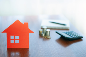 Buying and selling houses and real estate prices. Concept. Man using calculator to count rent money.