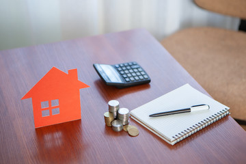 Buying and selling houses and real estate prices. Concept. Man using calculator to count rent money.