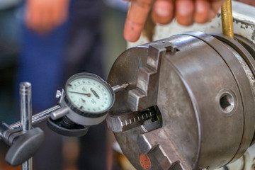 the device for measuring the end runout. Concept micrometer with measuring scale and indicator, lathe, profession Turner, equipment, beat check.