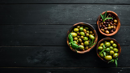 Olives in a bowl, olive oil, spices and herbs. Top view. Free space for your text.