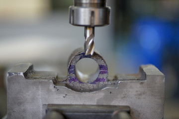 Traditional vertical metal milling machine. In the vertical mill the spindle axis is vertically oriented. Milling cutters are held in the spindle and rotate on its axis