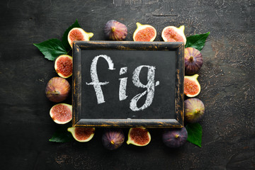 Figs on wooden background. Tropical fruits. Top view. Free copy space.