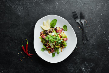 Vegetable salad with prosciutto and nuts. Food. Top view. Free space for your text.