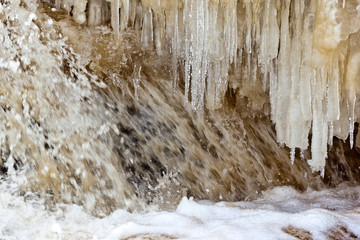 Fototapeta na wymiar Snow covered icy waterfall for postcard