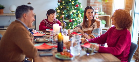 Beautiful family smiling happy and confident. Eating roasted turkey celebrating christmas at home