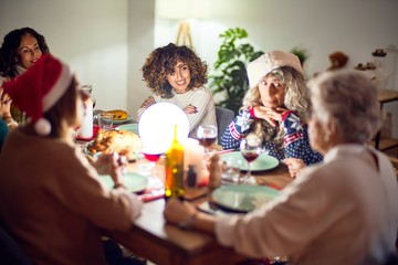 Beautiful group of women smiling happy and confident. Eating roasted turkey celebrating christmas at home
