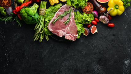 Raw veal steak with vegetables. Healthy eating concept. Top view. Free copy space.