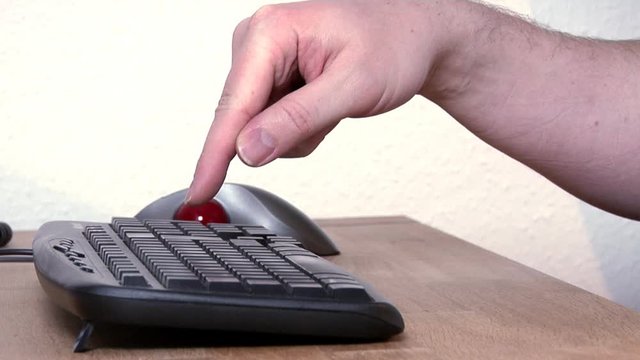 Man slowly typing the words I Love you! with single finger, obviously searching for each key separately.