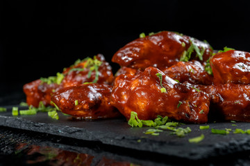 Chicken Wings with tomato barbecue sauce. Sprinkled with dill, onions and parsley.