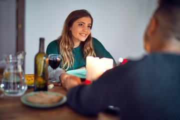 Young beautiful couple smiling happy and confident. on romantic meeting at home