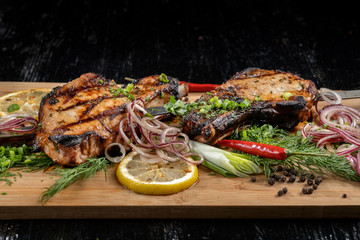 Juicy barbecue pork ribs beer, snacks lie on a wooden tray.