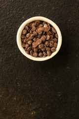 chocolate drops (black or milk chocolate, sweet ingredient) menu concept. food background. copy space. Top view