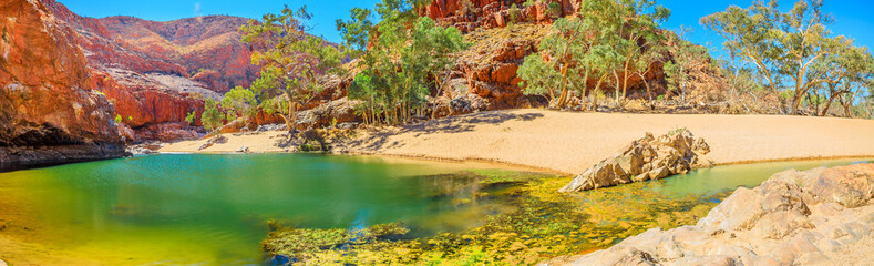 Banner panorama of Ormiston Gorge Water Hole with ghost gum in West MacDonnell Ranges, Northern Territory, Australia. Ormiston Gorge is a great place to swim or see the high walls of gorge and pound. © bennymarty