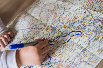 Child draw on the map with pen.