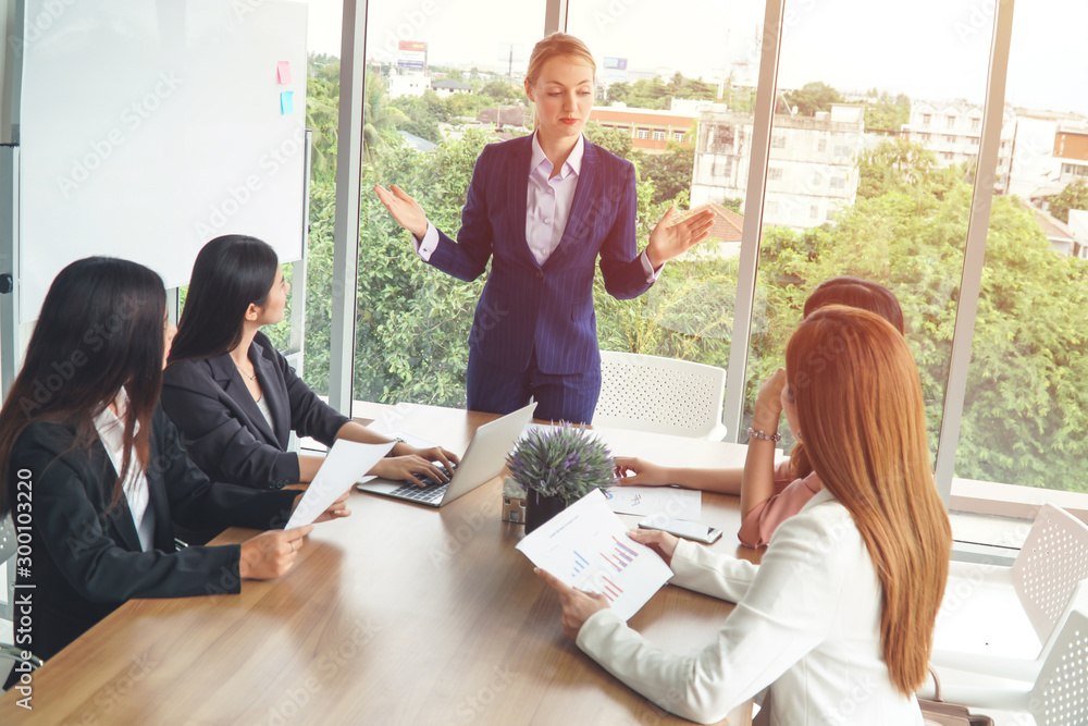 Canvas Prints a female caucasian manager with female asian employee during the meeting/briefing.