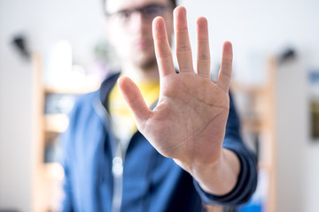 Defense or stop gesture: Male hand with stop gesture