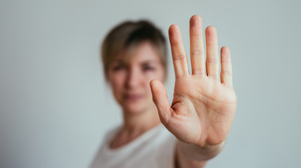 Defense or stop gesture: Girl hand with stop gesture