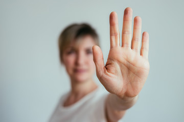 Defense or stop gesture: Girl hand with stop gesture