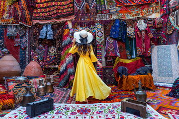 Beautiful girl at traditional carpet shop in Goreme city, Cappadocia in Turkey. - obrazy, fototapety, plakaty
