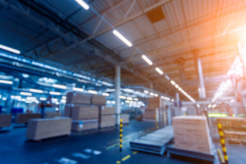 Fototapeta premium Bloored background of production line of the wooden floor factory. CNC automatic woodworking machine.