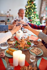 Beautiful family meeting smiling happy and confident. Eating roasted turkey toasting with cup of wine celebrating Christmas at home