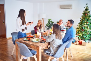 Beautiful family meeting smiling happy and confident. Speaking speech eating roasted turkey celebrating Christmas at home