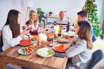 Beautiful family meeting smiling happy and confident. Eating roasted turkey celebrating Christmas at home