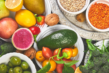 Alkaline diet food, Clean eating. Healthy vegetarian seasonal, fall food cooking background. Flat lay of Autumn vegetables and herb over grey concrete background, top view, copy space.