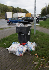 Overfilled garbage bin on the highway. North Rhine-Westphalia, Germany, Europe